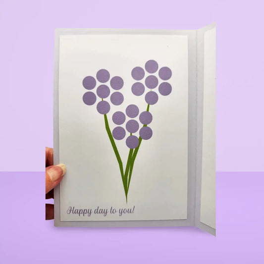 Greeting card with purple flowers and 'Happy day to you!' text on a light purple background