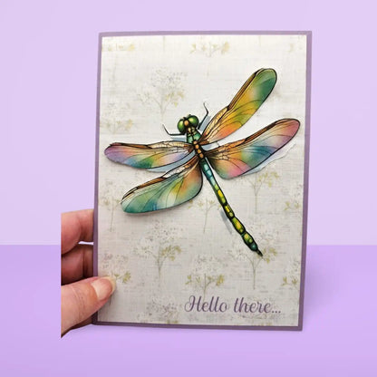 Card with a colorful dragonfly illustration and 'Hello there...' text on a textured background.