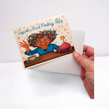 Card with cartoon character and 'Cupcake-Sized Kindness Notes' text, held by a hand.