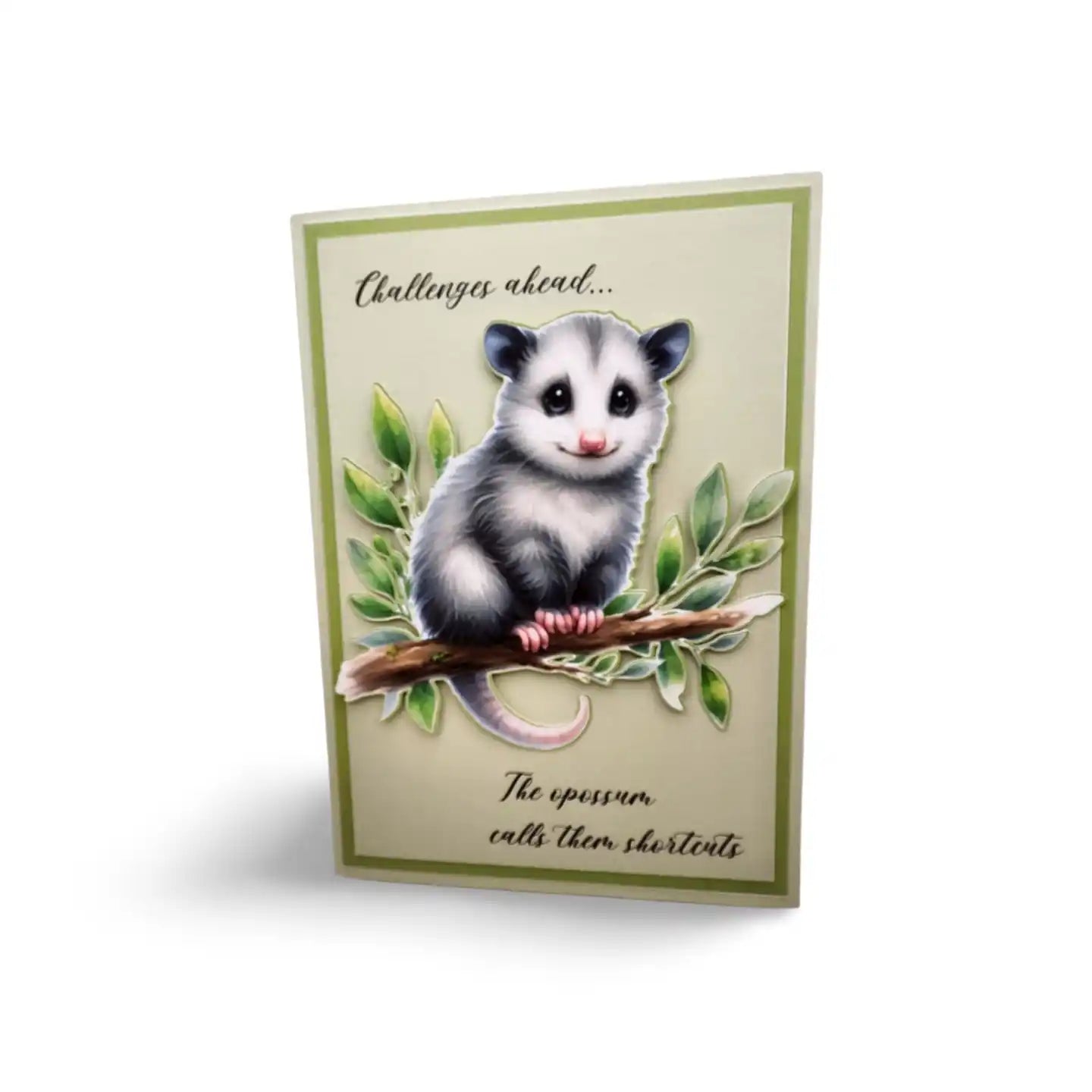 Card with an opossum illustration on a branch, surrounded by leaves, on a beige background.