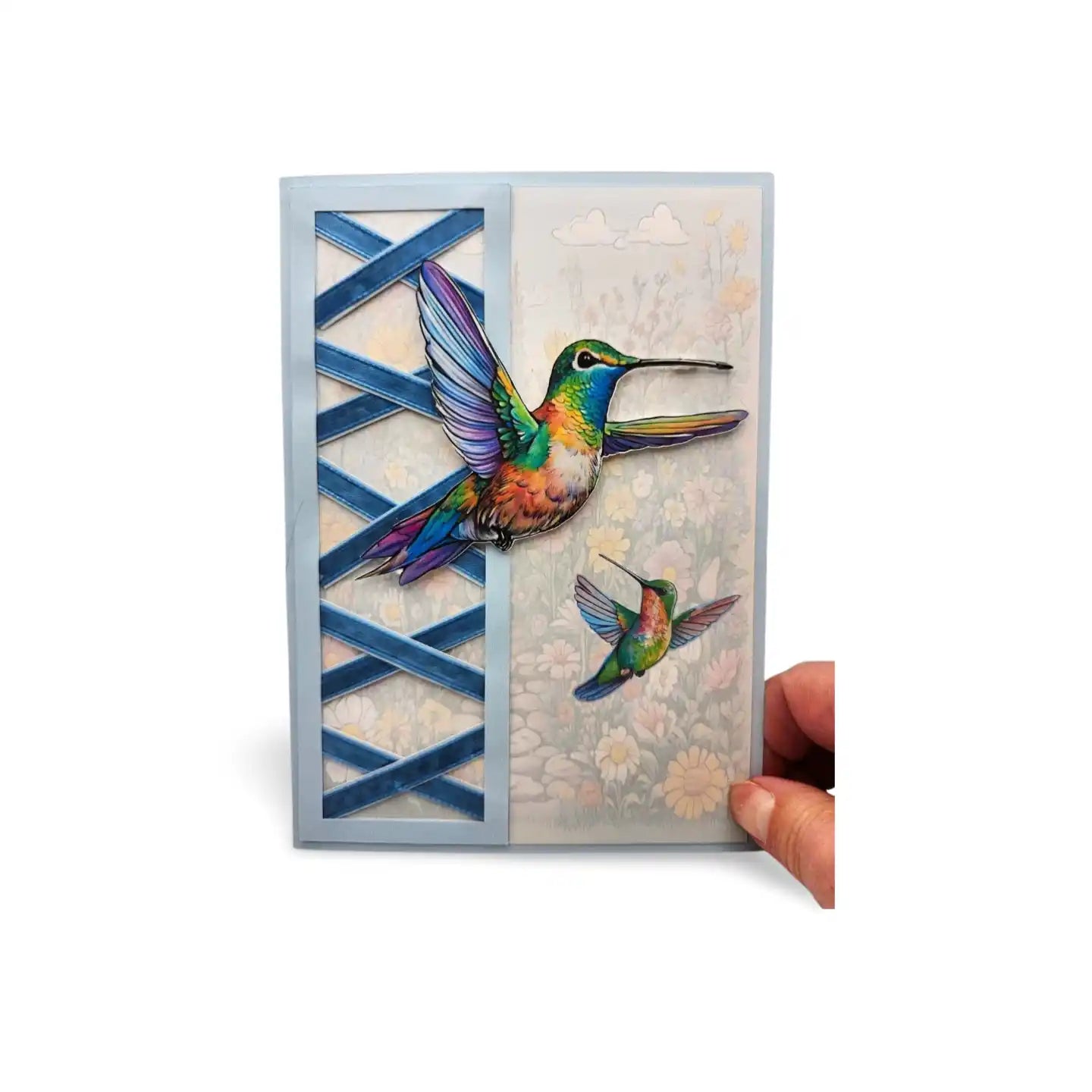 Card with colorful hummingbird design held by a hand on a white background