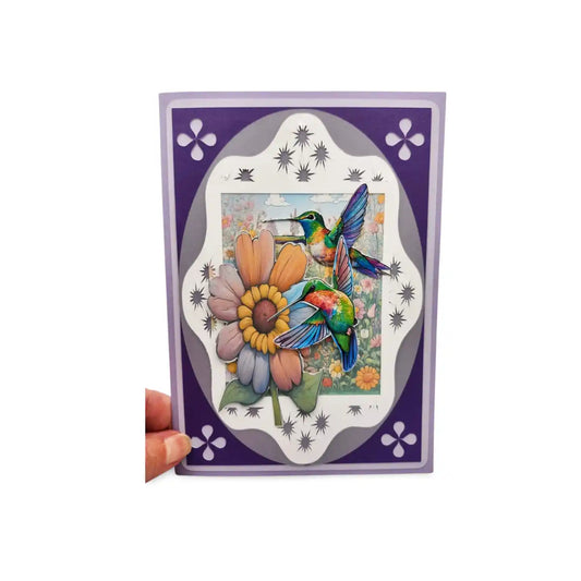 Card with a colorful illustration of a hummingbird and flowers on a purple border.