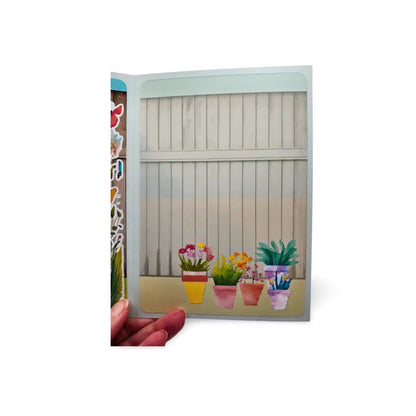 Card with a design of potted plants in front of a fence