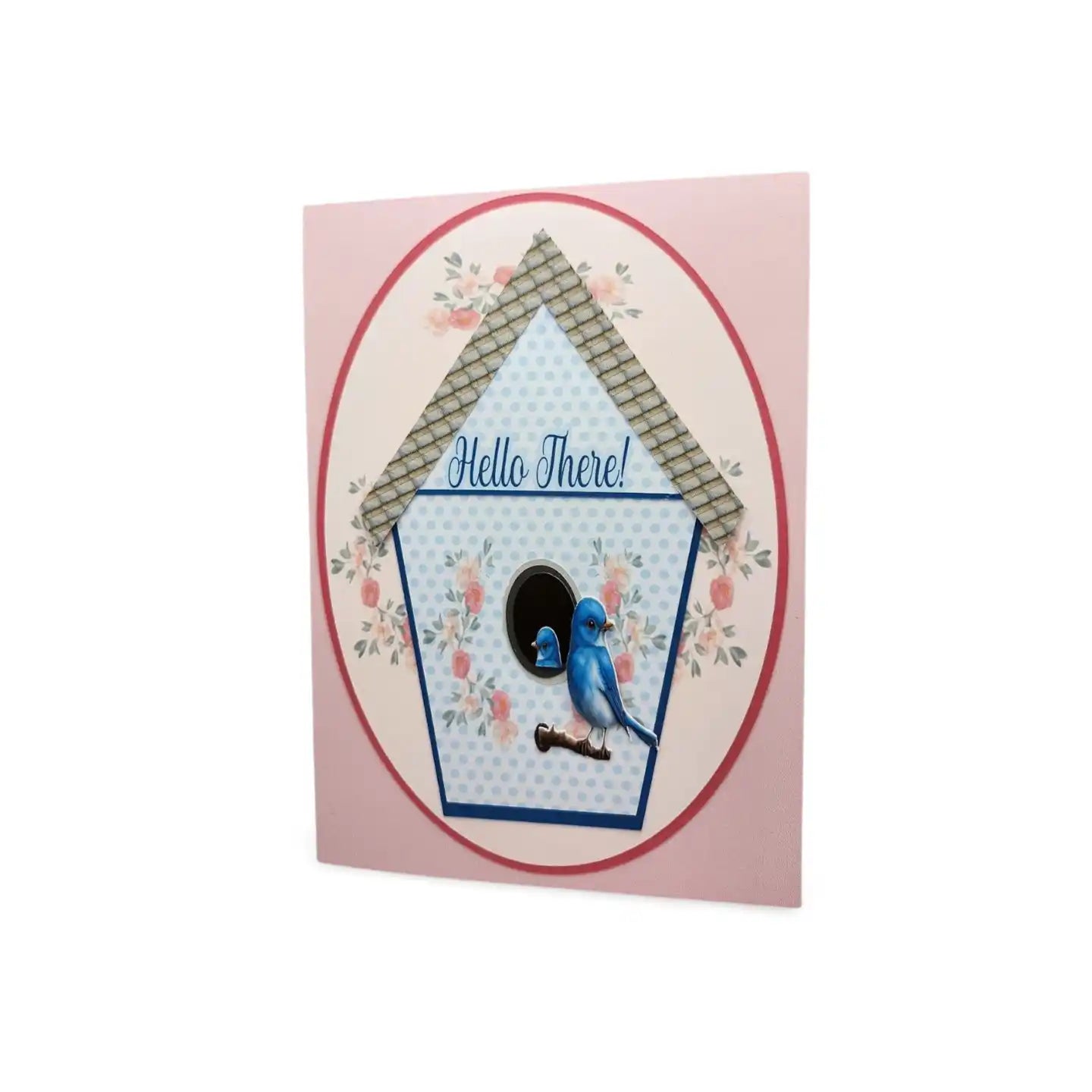 Card with a birdhouse design and a blue bird illustration on a pink background
