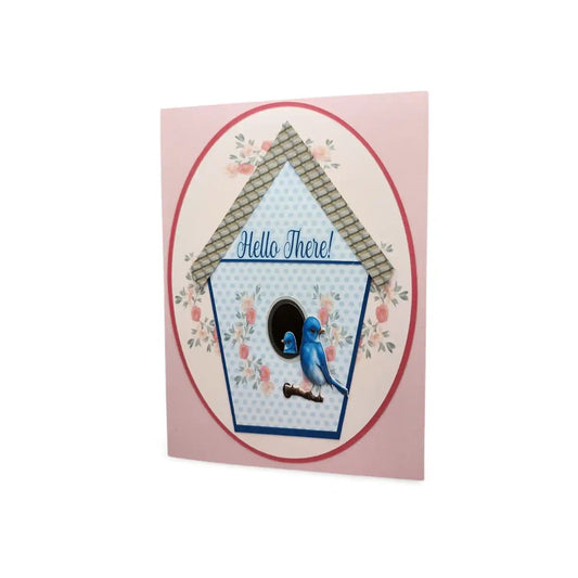 Card with a birdhouse design and a blue bird illustration on a pink background
