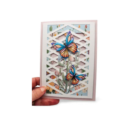 Card with colorful butterfly design held by a hand on a white background