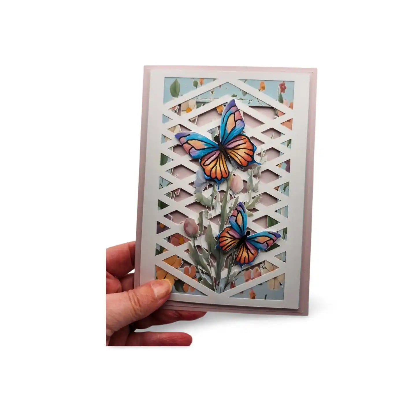 Card with butterfly design held by a hand on a white background