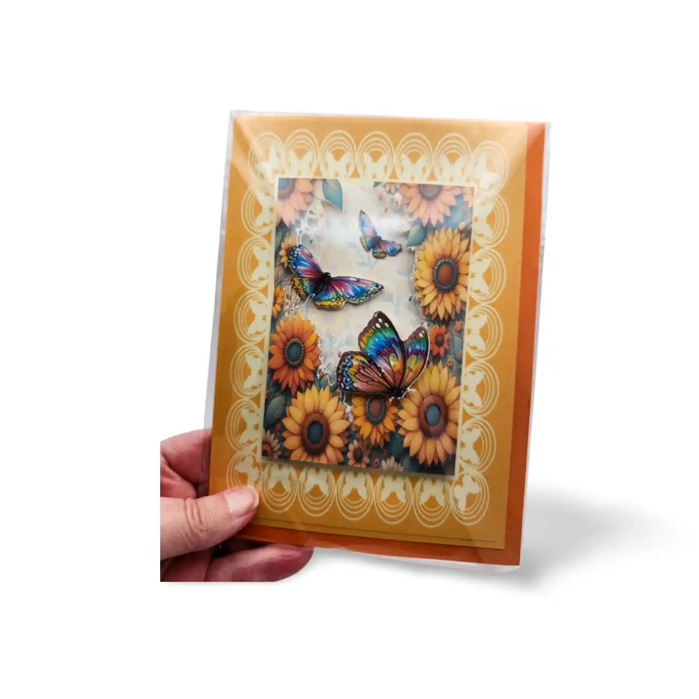 Card with sunflowers and butterflies held by a hand on a white background