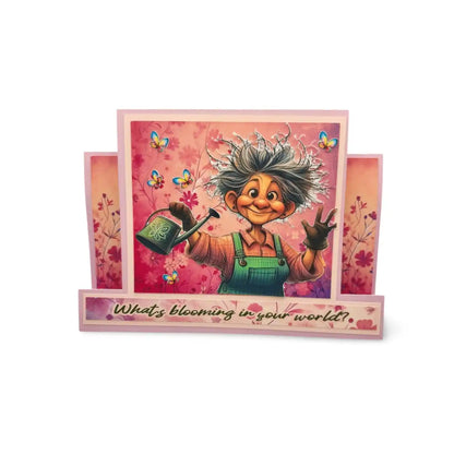Greeting card with a cartoon character holding a watering can and flowers, with text 'What's blooming in your world?'