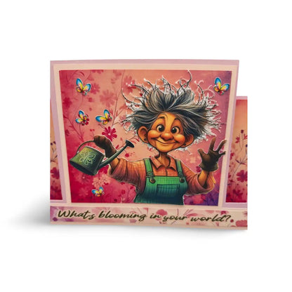 Greeting card with cartoon character holding a watering can and text 'What's blooming in your world?' on a pink floral background.