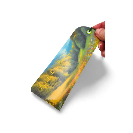 Colorful bookmark held by a hand on a white background