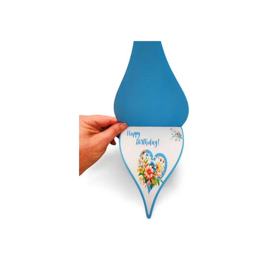 Hand holding a blue birthday card with floral design and 'Happy Birthday' text on a white background