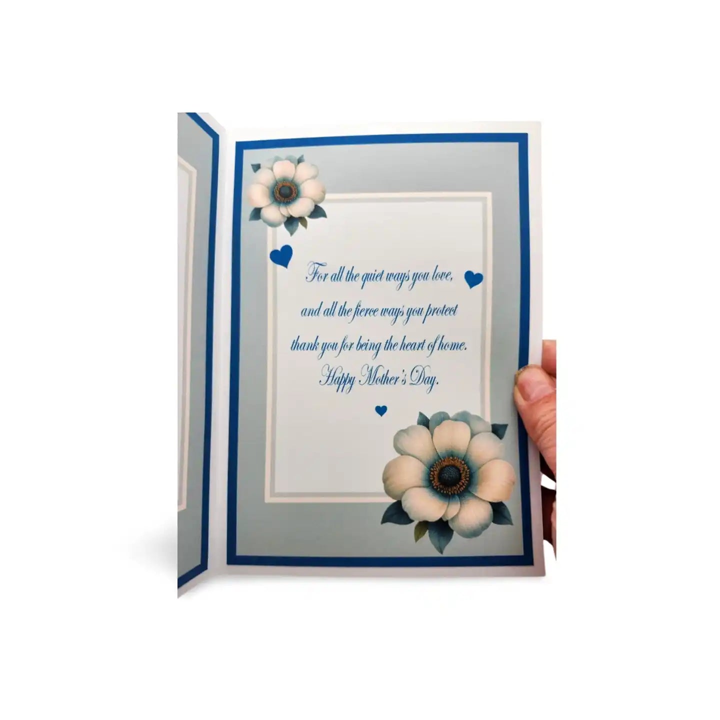 Greeting card with floral design and Mother's Day message, held open by a hand.