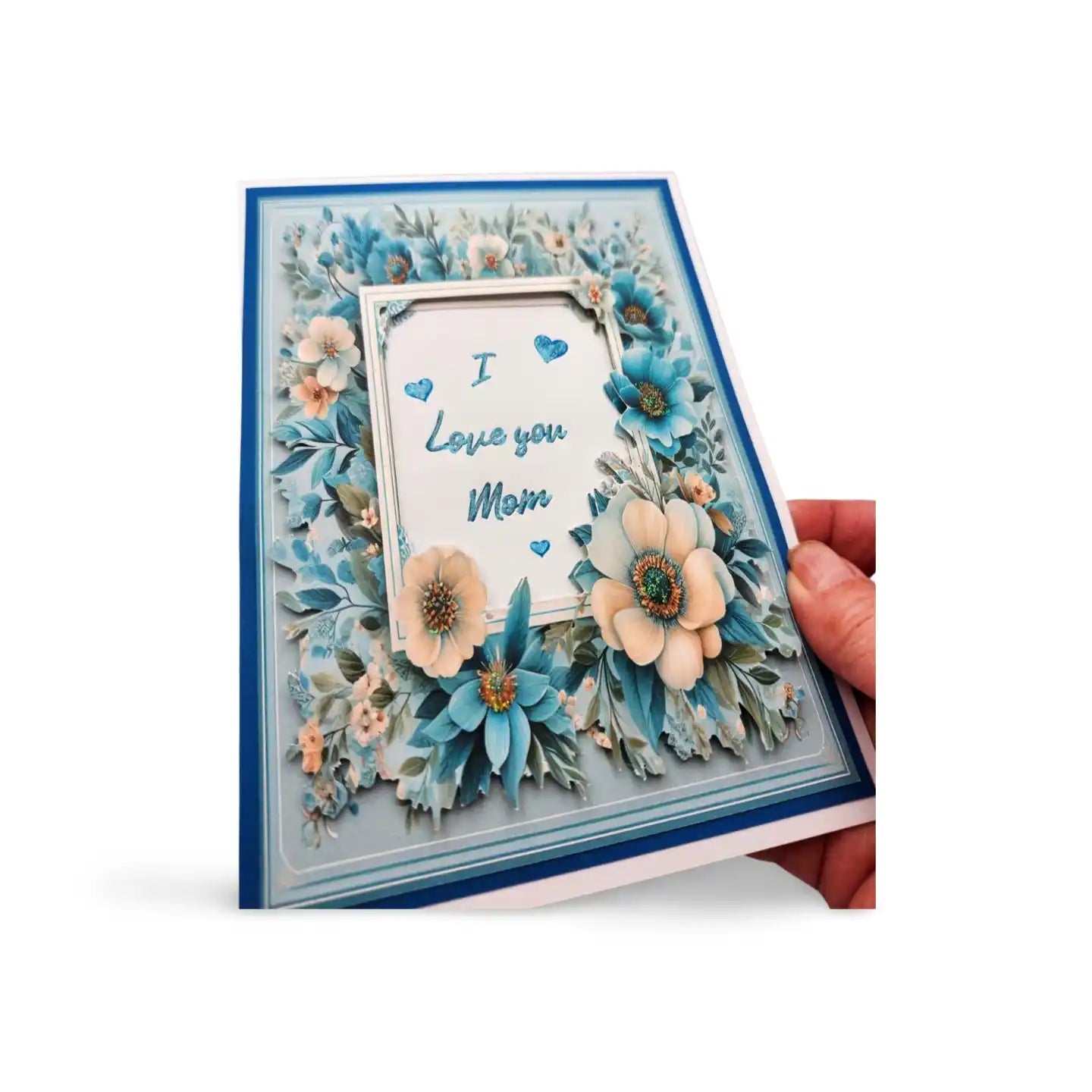 Greeting card with floral design and 'I Love you Mom' text, held by a hand on a white background.