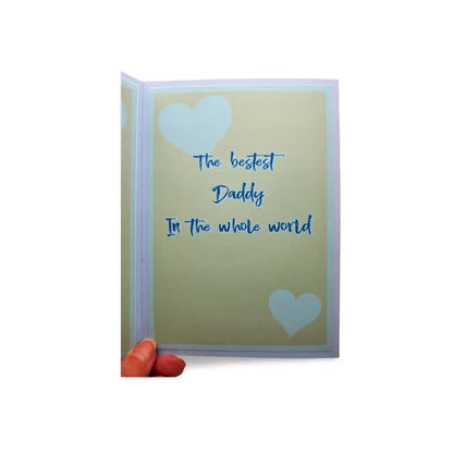 Greeting card with 'The bestest Daddy In the whole world' text and heart designs on a beige background.