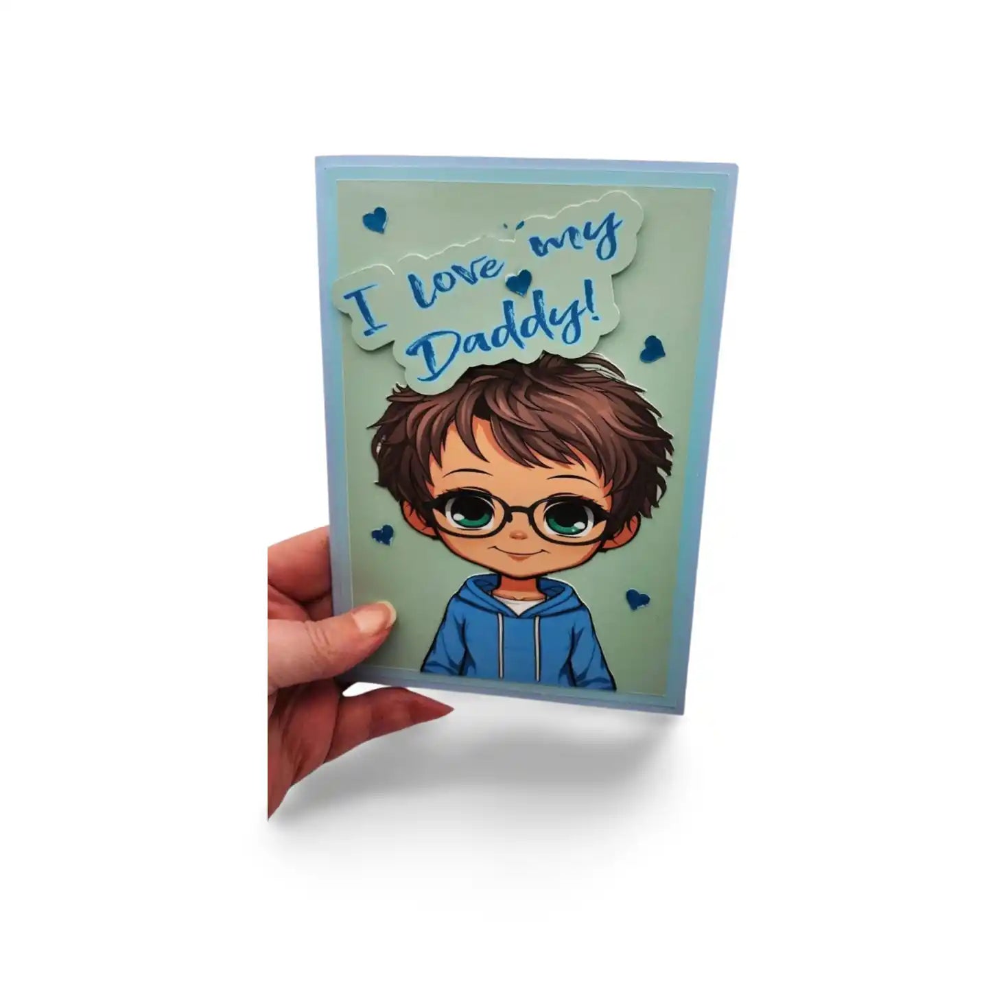 Card with a child's illustration and 'I love my Daddy!' text held by a hand on a white background