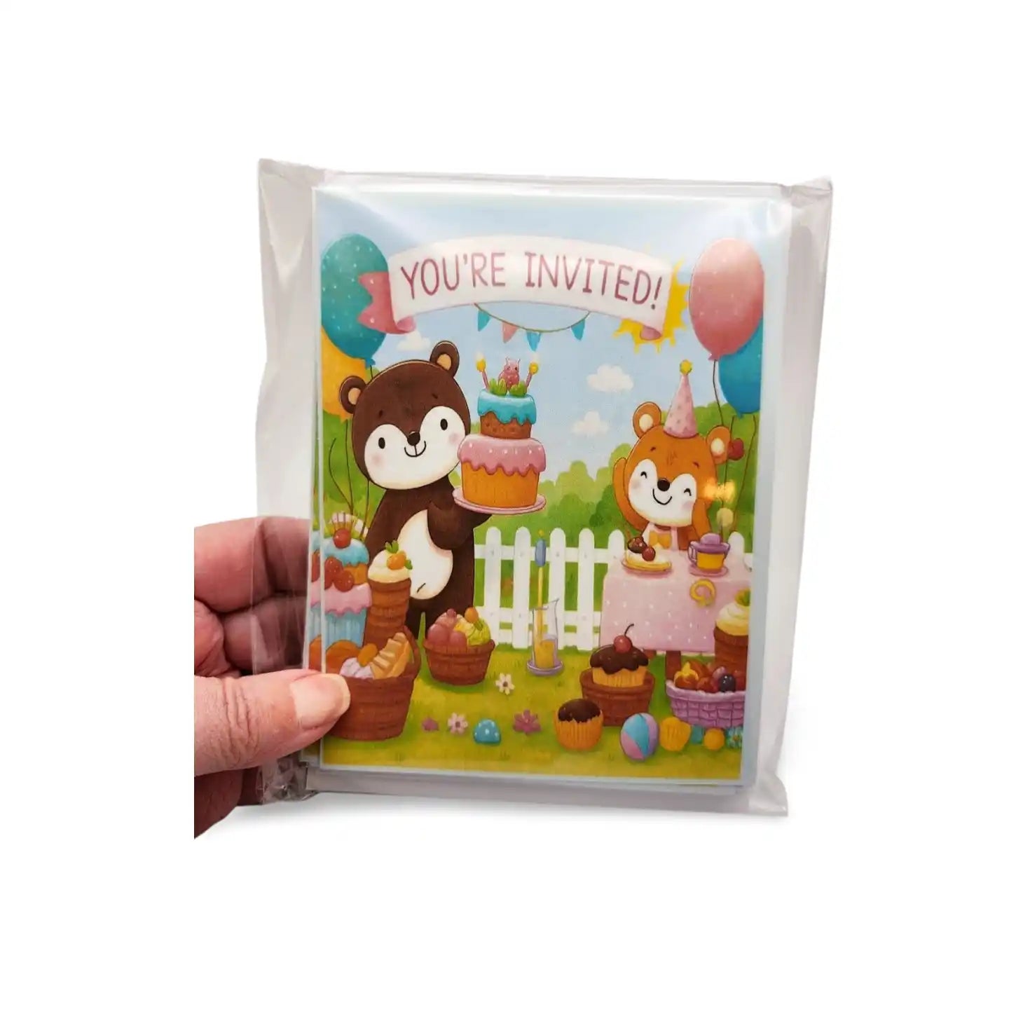 Invitation card with cartoon animals and 'You're Invited!' text held by a hand.