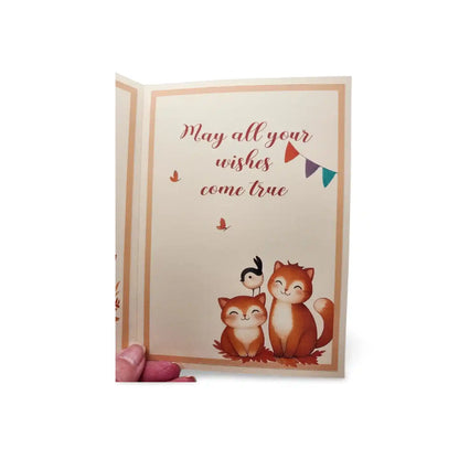 Greeting card with foxes and a penguin, featuring the text 'May all your wishes come true'.