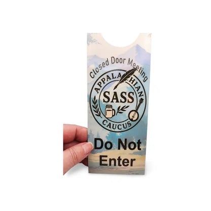 Hand holding a 'Do Not Enter' sign with Appalachian SASS logo on a white background