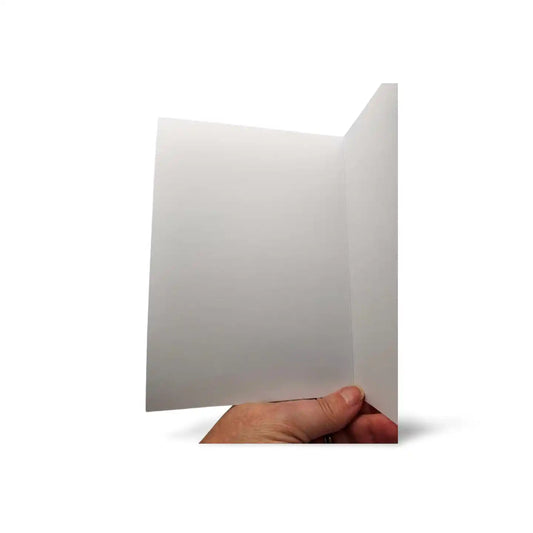 Hand holding a white card against a white background