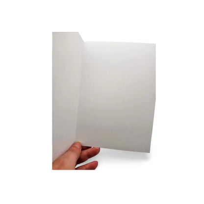 Hand holding a white card against a white background