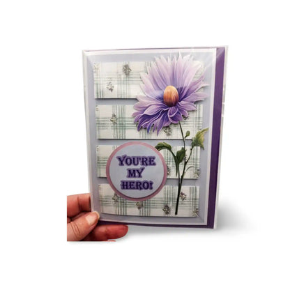 Greeting card with purple flower and 'You're My Hero!' text on a white background