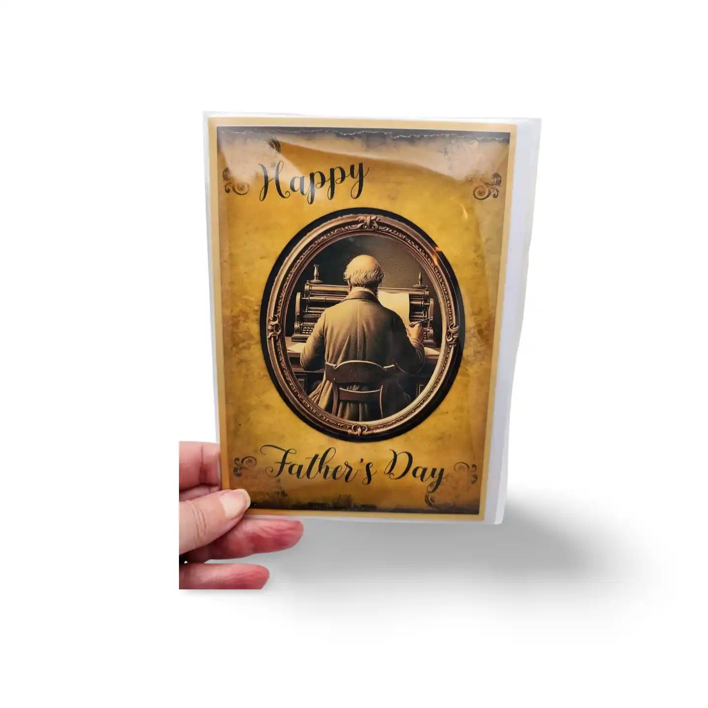 Father's Day card with a gold border and photo of a man, held by a hand on a white background.