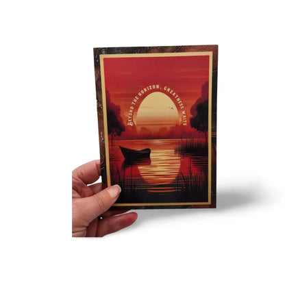Hand holding a postcard with a sunset design and text on a white background