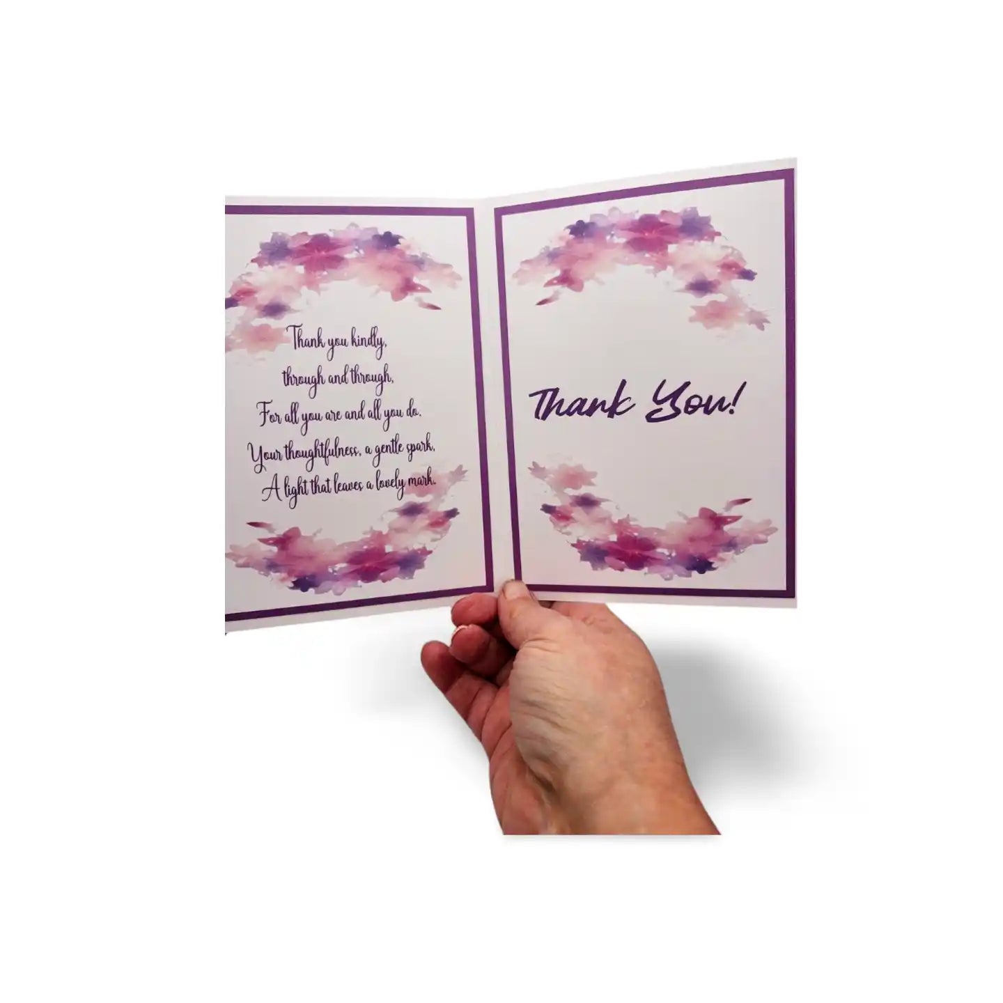 Hand holding a card with 'Thank You' message and watercolor design on a white background
