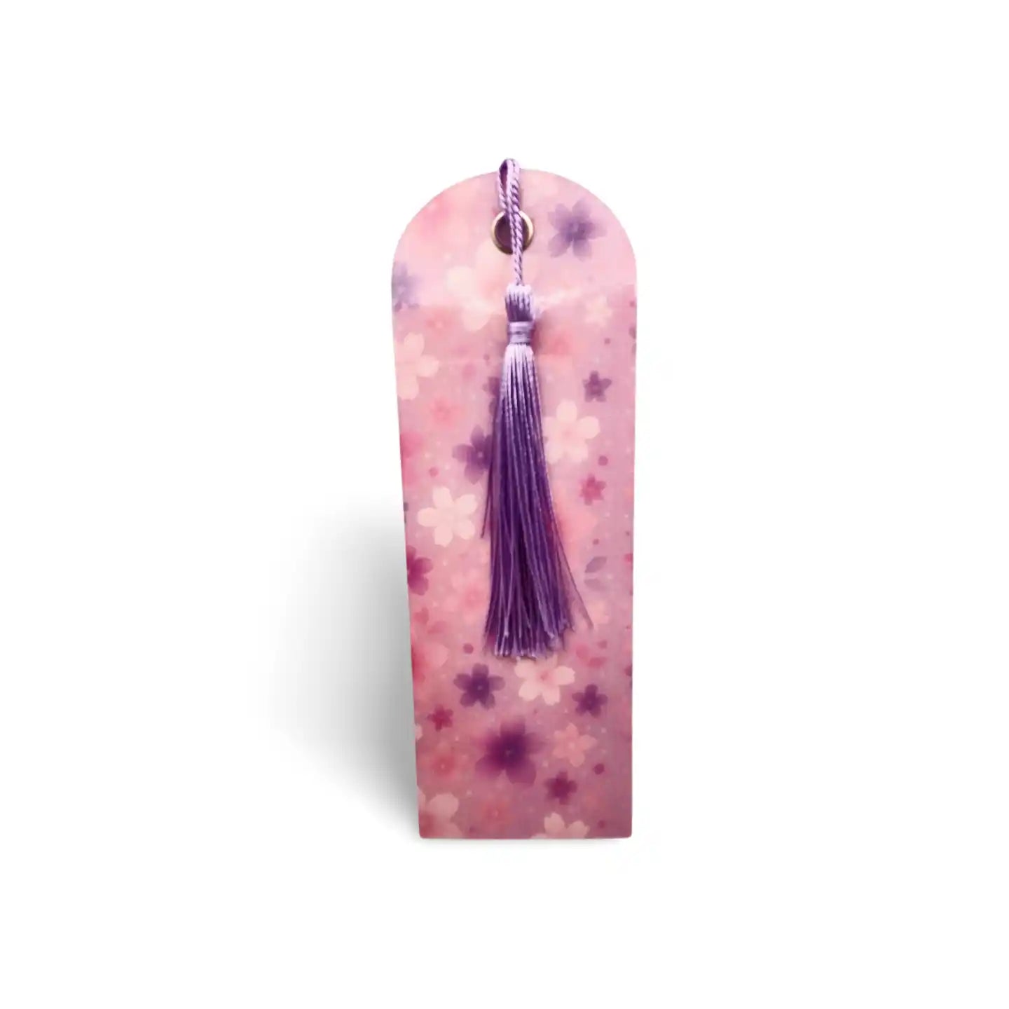 Decorative bookmark with a tassel on a pink floral background