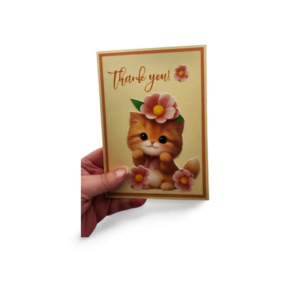 Card with a cat illustration and 'Thank you!' text held by a hand on a white background