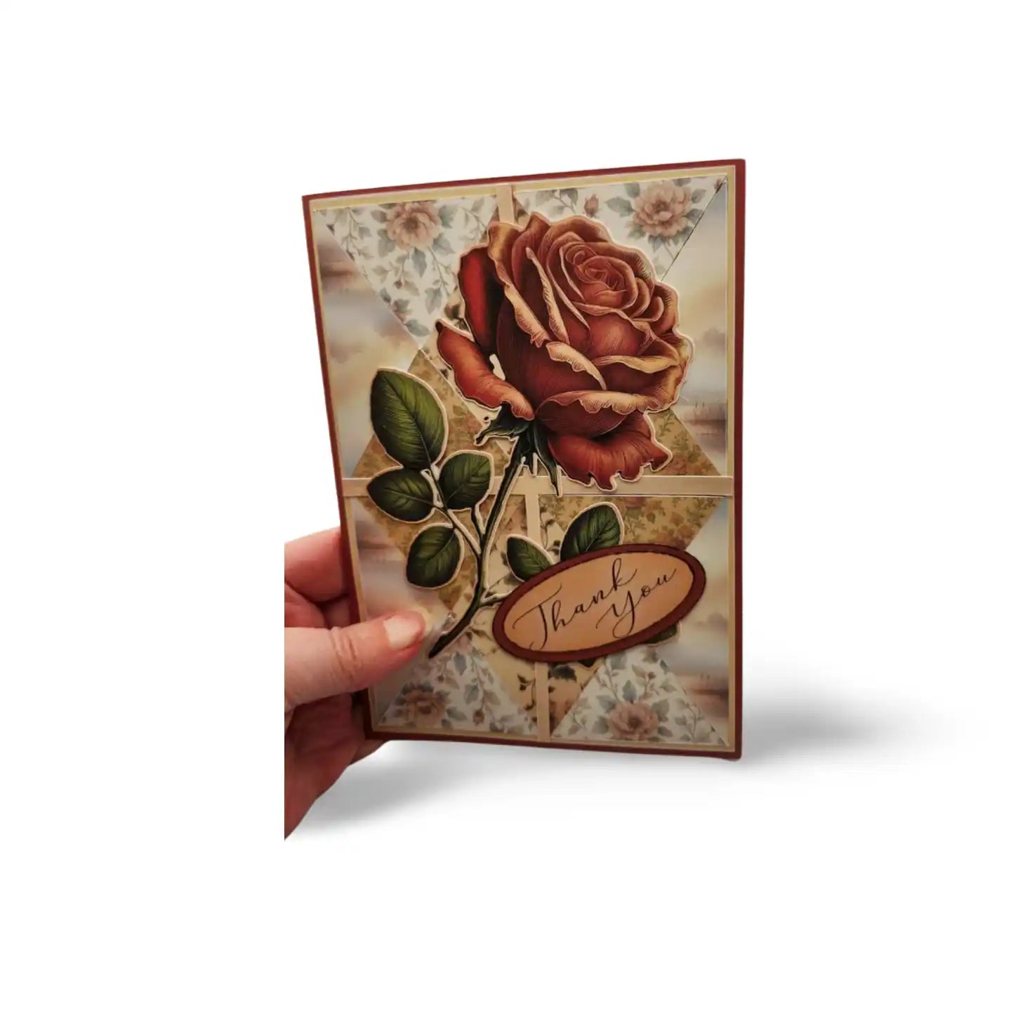 Card with a rose design and 'Thank you' message held by a hand on a white background