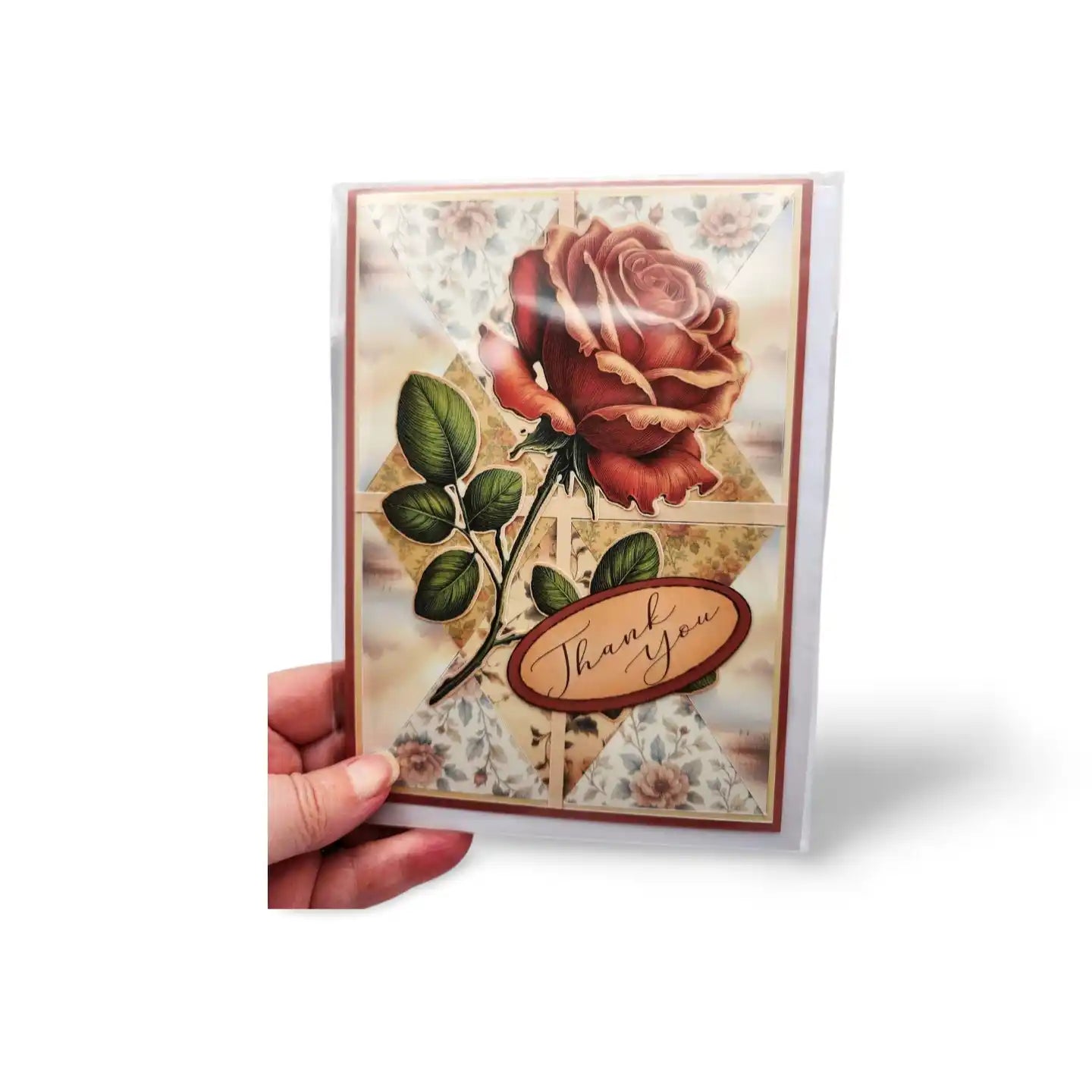 Greeting card with a red rose and 'Thank you' text held by a hand on a white background