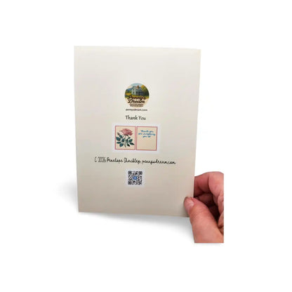 Hand holding a card with a visible brand logo on a white background