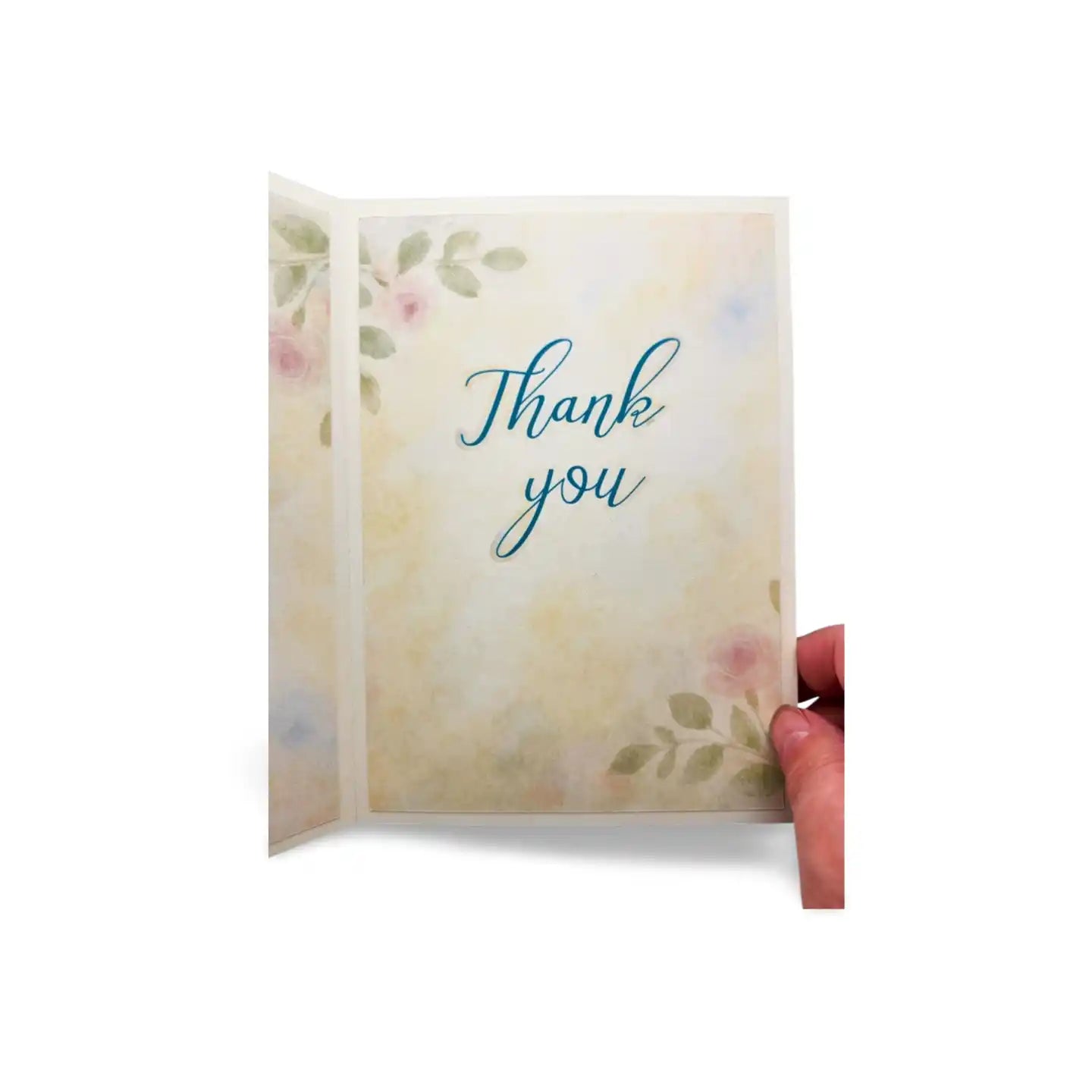 Card with 'Thank you' text and floral design held by a hand on a white background