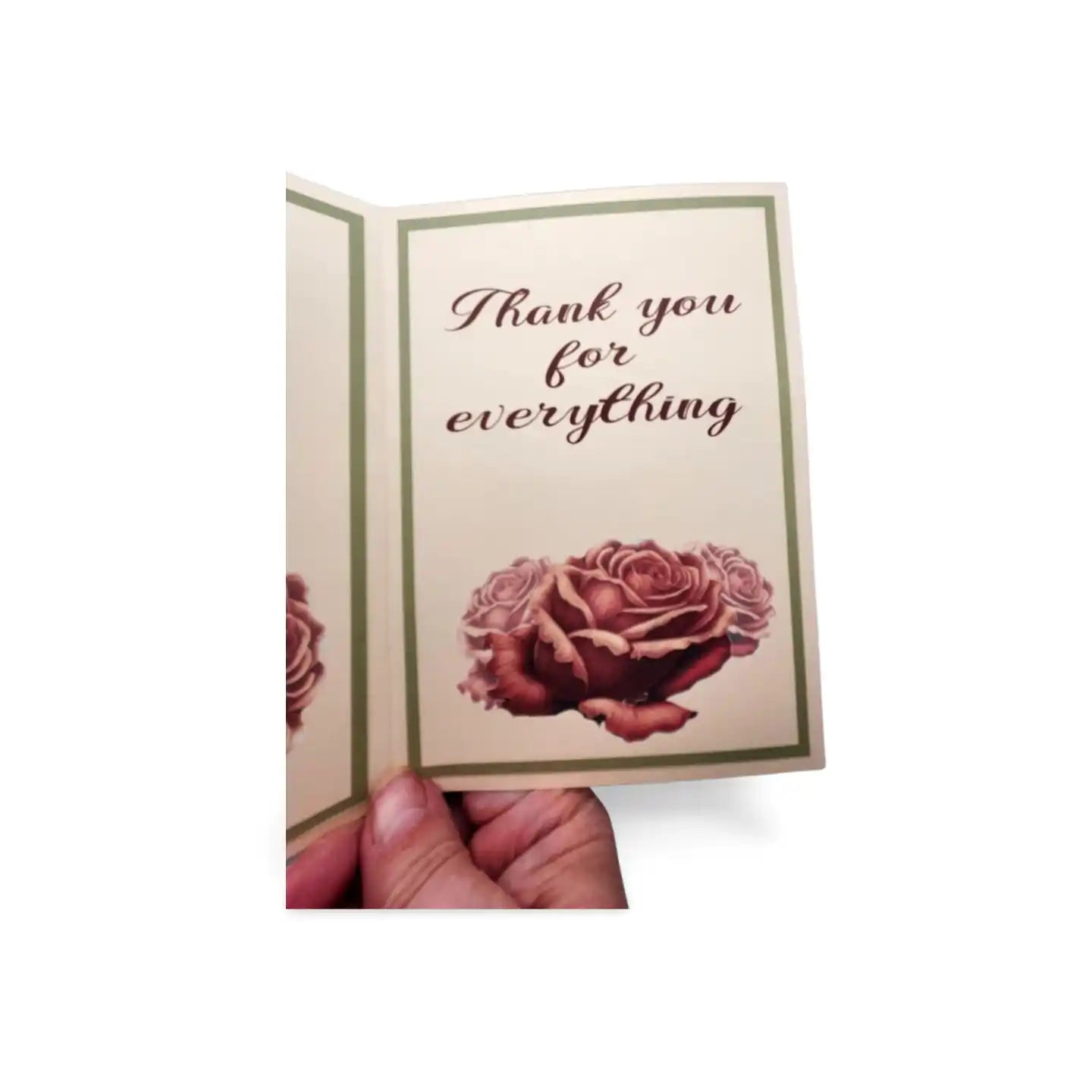 Card with roses and 'Thank you for everything' text held by a hand on a white background
