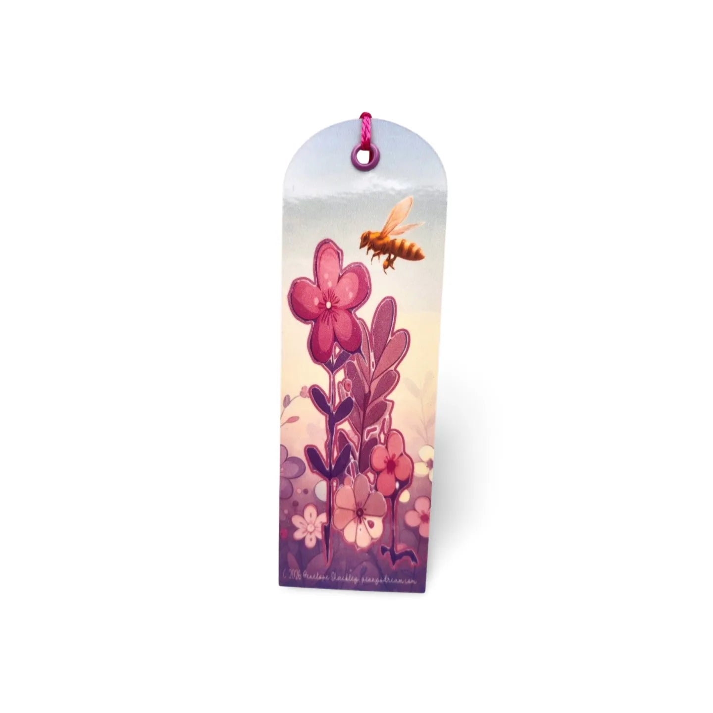 Decorative bookmark with floral design and bee illustration on a white background