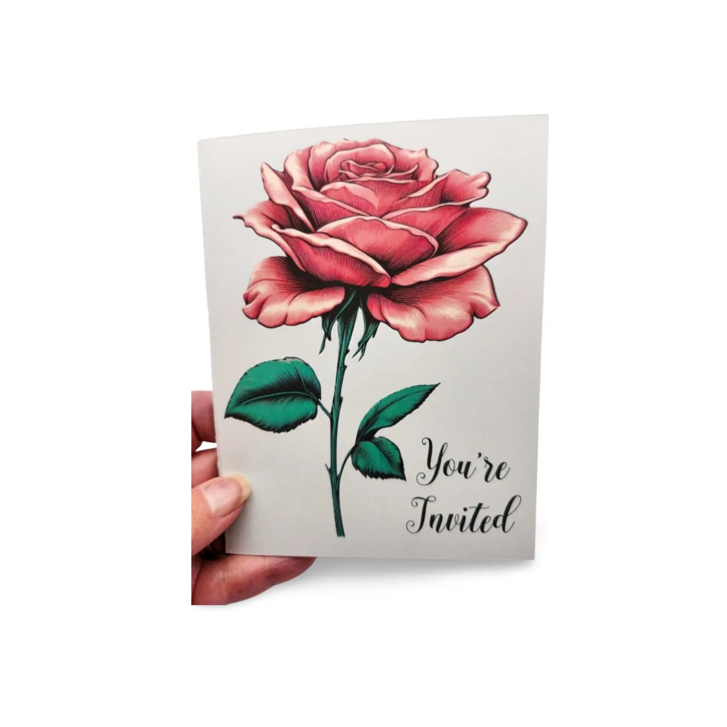 Card with a pink rose and 'You're Invited' text held by a hand on a white background