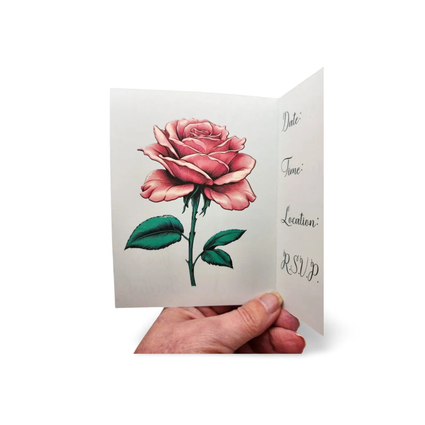 Greeting card with a pink rose design held by a hand on a white background