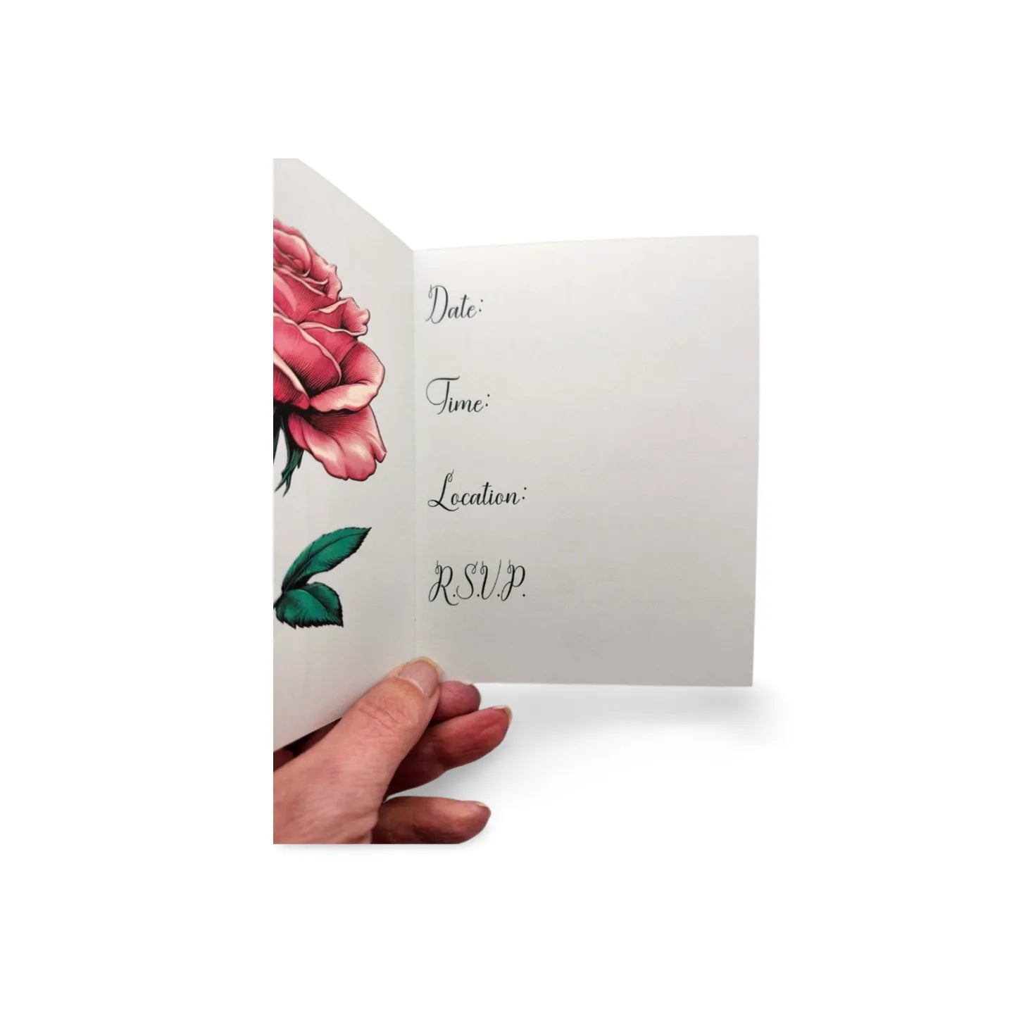 Hand holding an open invitation card with floral design and text on a white background