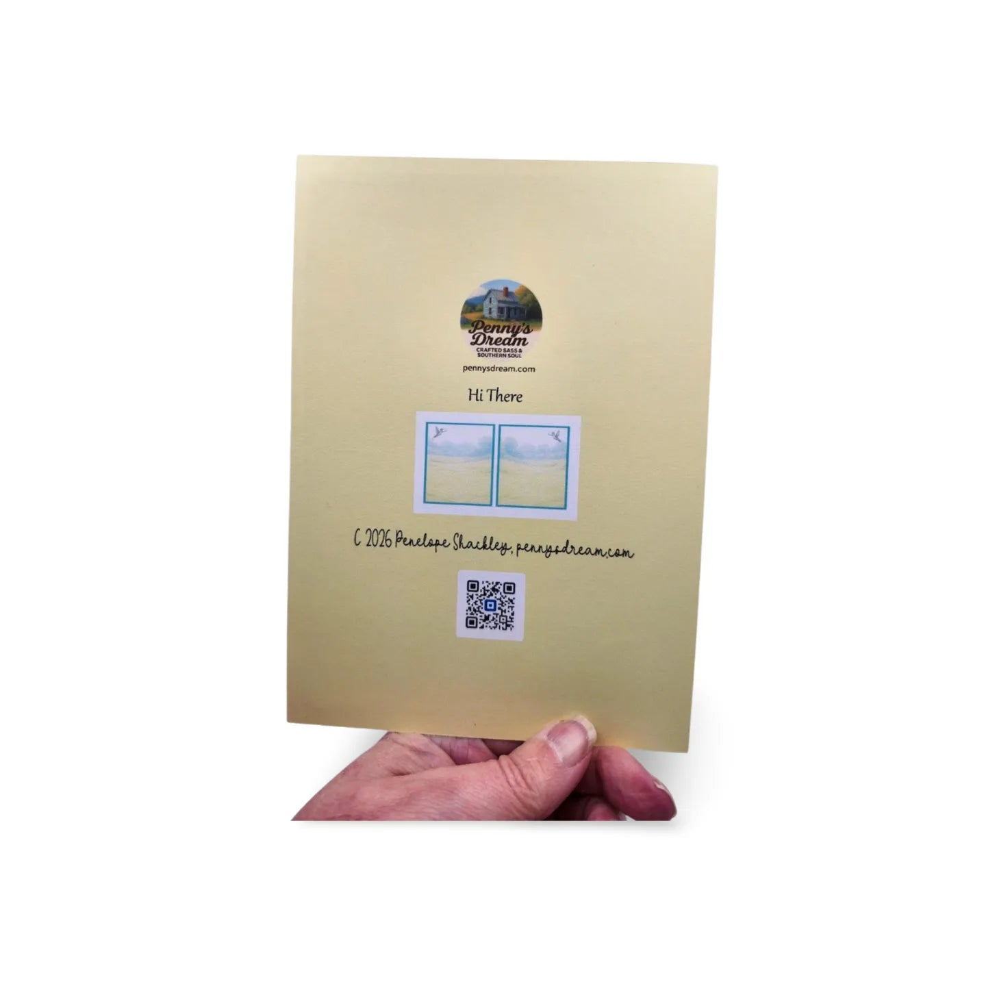 Beige greeting card held by a hand with a visible brand logo on a white background