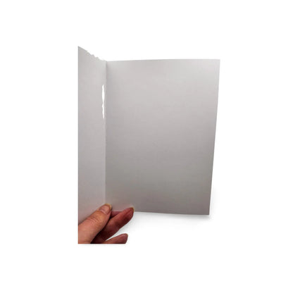 Hand holding a white card against a white background