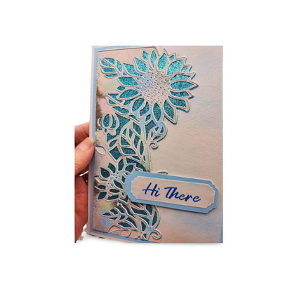 Card with floral design and 'Hi There' tag held by a hand on a white background