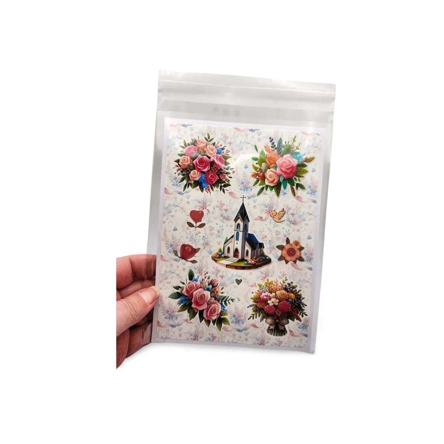 Pack of floral and church-themed stickers held by a hand on a white background
