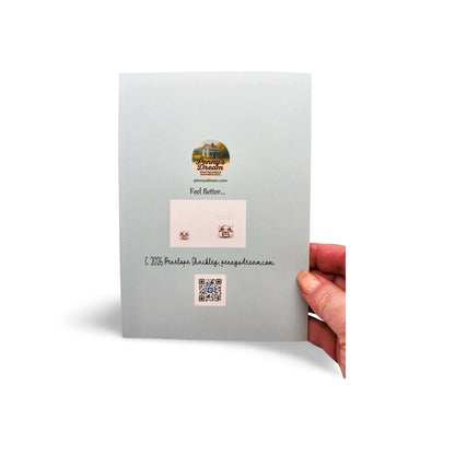 Card with earring display and QR code held by a hand on a white background