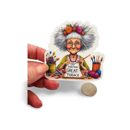Sticker of an elderly woman with a sign 'Do Something Great Today' held by a hand.