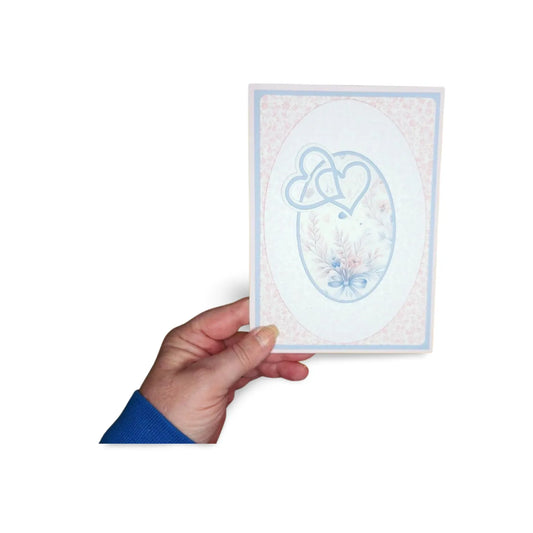 Hand holding a card with a blue heart design on a white background