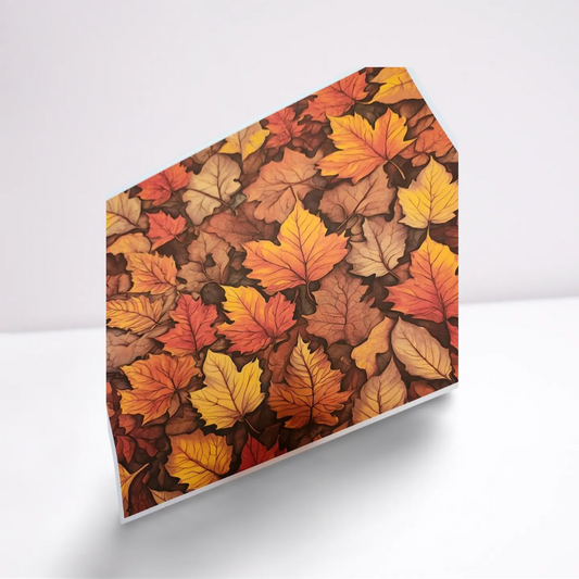 Hexagonal paperweight with autumn leaf pattern on a white background
