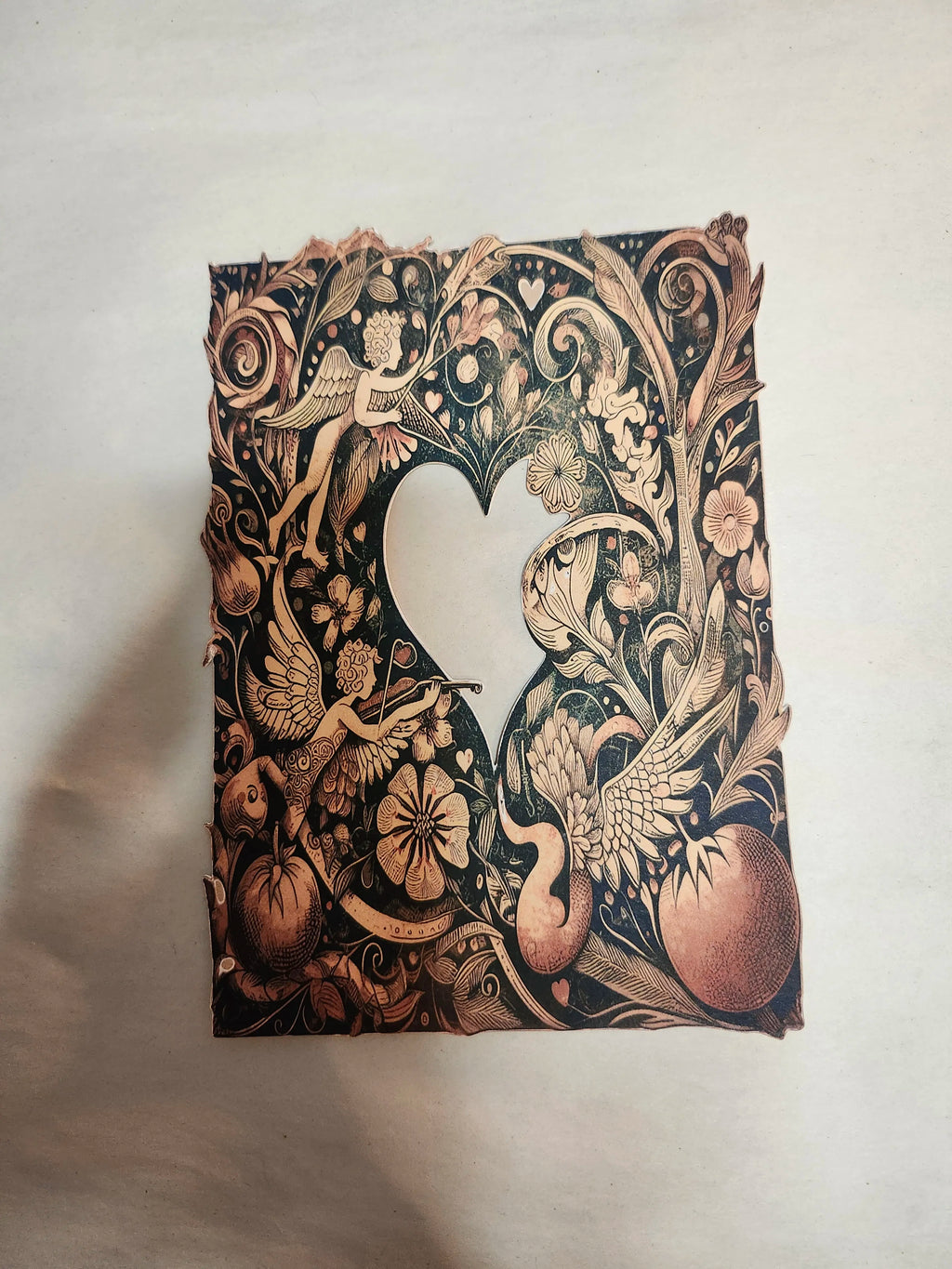 Decorative notebook with intricate black and gold design on a light background