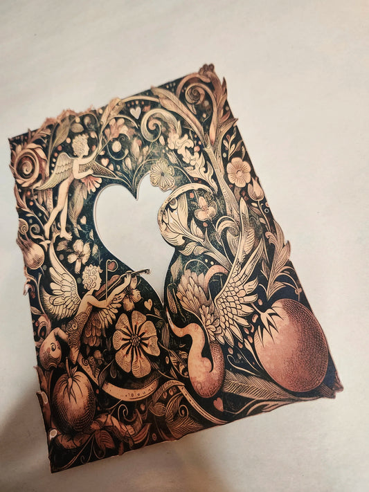 Decorative notebook cover with intricate gold and black designs on a light background